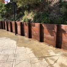 A retaining wall that stops downhill drainage and adds beauty to a slopeinstalled by Lamorinda Deck Installer