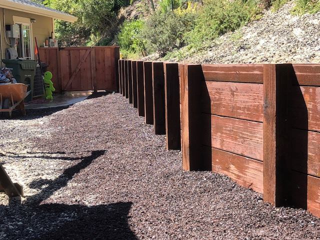 A retaining wall that stops downhill drainage and adds beauty to a slopeinstalled by Lamorinda Deck Installer